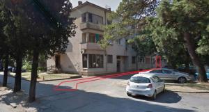 a car parked in a parking lot in front of a building at Amazon Hostel Center Podgorica in Podgorica