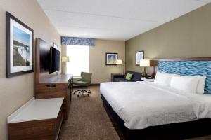 a hotel room with a bed and a television at Hampton Inn Buffalo-South/I-90 in West Seneca +60 photos