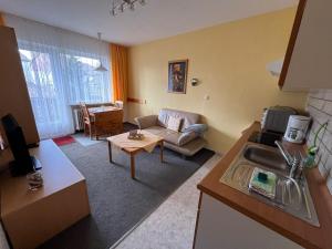 a living room with a couch and a table at Haus Panorama Sankt Andreasberg in Sankt Andreasberg