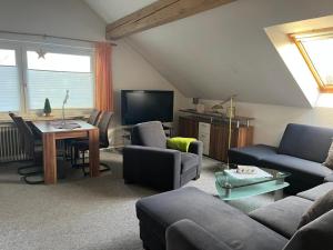 a living room with a couch and a table at Haus Panorama Sankt Andreasberg in Sankt Andreasberg