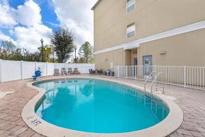 a swimming pool in front of a building at Country Inn & Suites by Radisson, Jacksonville West, FL in Jacksonville