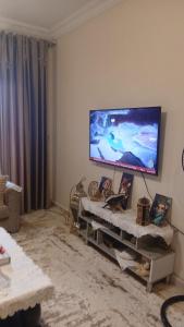 a living room with a flat screen tv on the wall at فينوس in Hurghada