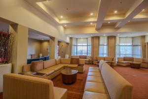 a waiting room with couches and tables and windows at Country Inn & Suites by Radisson, Convention Center in Altoona +194 photos