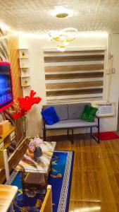 a living room with a couch and a table at Ciel's Deluxe Haven in Binangonan