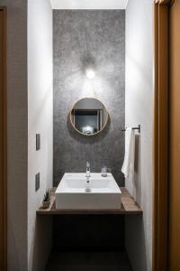 a bathroom with a white sink and a mirror at THE CITYSCAPE in Kita-sanjō +86 photos