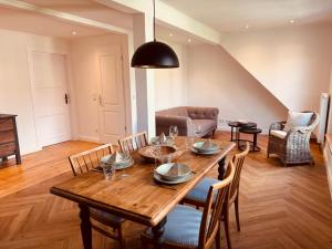 a dining room with a wooden table and chairs at Residenz Moselliebe Traben in Traben-Trarbach