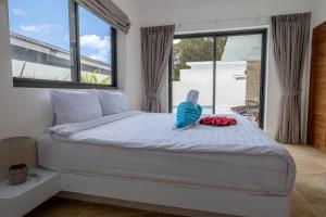 a bedroom with a bed with a bird sitting on it at villa carissa 9 in Nathon Bay