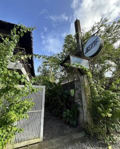 a sign on the side of a house with a gate at jbsurf House in Catagnan +8 photos