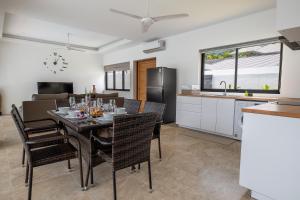 a kitchen and dining room with a table and chairs at villa carissa 9 in Nathon Bay