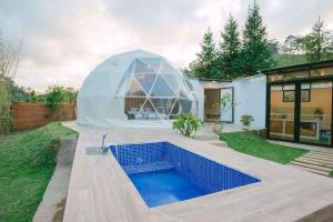 a dome house with a swimming pool in a yard at Shanti Wellness Sanctuary Đà Lạt in Da Lat
