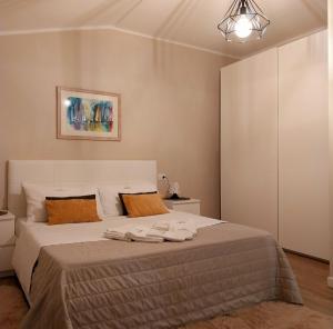 a bedroom with a bed with two towels on it at Il limone in Gargnano +51 photos