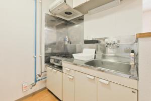 a kitchen with a sink and a stove at STAY IN PASSION in Asahikawa +30 photos