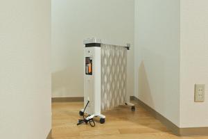 a room with a machine on a wooden floor at STAY IN PASSION in Asahikawa
