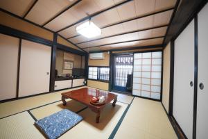 a room with a table and some windows at Oyado Iseya in Shiojiri