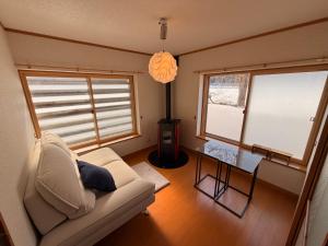 a living room with a couch and a table at HAYU Hearth Yuzawa in Yuzawa
