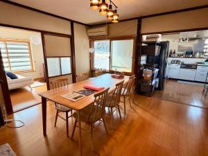 a kitchen and dining room with a table and chairs at HAYU Hearth Yuzawa in Yuzawa