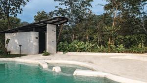 a swimming pool with a pavilion next to a swimming pool at Earth's Embrace in Kalpetta