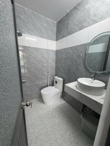 a bathroom with a toilet and a sink and a mirror at Muối Hồng Homestay in Ấp Tân Hà