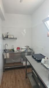 a kitchen with a sink and a table in it at VIP next TIME Casa Vacanta in Costinesti