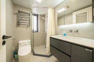 a bathroom with a toilet and a sink and a shower at Today-Lujiazui Riverside,Bund Riverview in Shanghai +37 photos