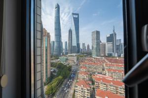 a view from a window of a city with tall buildings at Today-Lujiazui Riverside,Bund Riverview in Shanghai