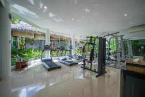 a gym with treadmills and ellipticals in a room at Sayang Sanur Duplex in Sanur