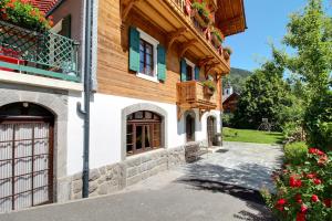 a building with a gate and a balcony at Garden Heart of the village Swedish Stove in Champéry