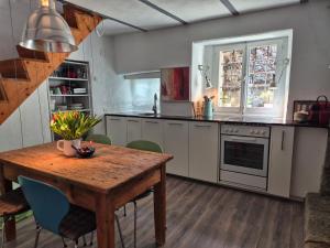 a kitchen with a wooden table and a dining room at Casa Grillino in Locarno