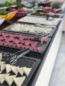 a table with several trays of food on it at Taşucu Kaptan Suit Otel in Silifke
