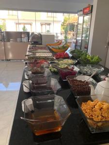 a buffet of food on a black counter top at Taşucu Kaptan Suit Otel in Silifke