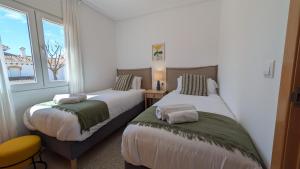 a bedroom with two beds and a window at Villa with private pool and BBQ on Mar Menor Golf Resort in Torre-Pacheco +28 photos