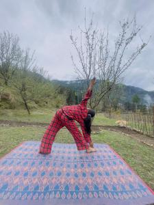 a person doing a handstand on top of a blanket at Mj home in Kalgha