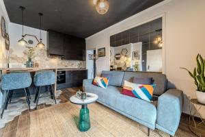 a living room with a blue couch and a kitchen at Villa Mart in Zadar
