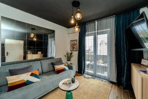 a living room with a couch and a large window at Villa Mart in Zadar