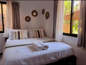 a bedroom with a bed with towels on it at Liminaya Villa in El Nido