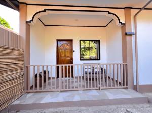 a front porch of a house with a wooden door at Liminaya Villa in El Nido