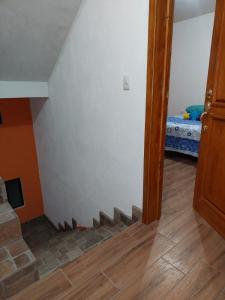 a room with a staircase leading to a bedroom at Armonías 2 in Panajachel