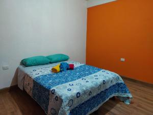 a bedroom with a bed with a blue comforter at Armonías 2 in Panajachel