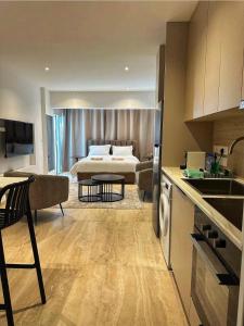 a hotel room with a bed and a kitchen and a room at J Aurora in Nicosia