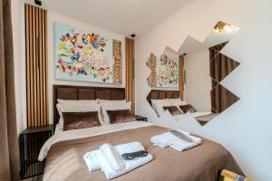 a bedroom with a large bed with towels on it at Villa Mart in Zadar