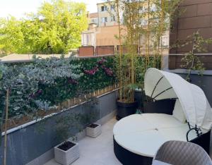 a patio with a white table and some plants at Aura Spa Oberhausen Premium in Oberhausen