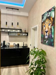a kitchen with a painting of a tiger on the wall at Aura Spa Oberhausen Premium in Oberhausen
