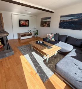 a living room with a couch and a coffee table at Chalet Annemie in Mendig