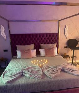 a bedroom with a large bed with lights on it at Aura Spa Oberhausen Premium in Oberhausen