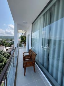 two benches on the balcony of a house at Villa caribe phu quoc in Phú Quốc