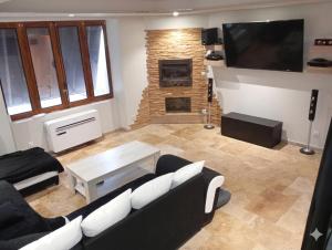 a living room with a couch and a fireplace at L oxygène ardéchois gîte 3 in Ruoms