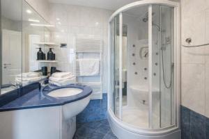 a bathroom with a sink and a shower at House Lenart in Bled +19 photos