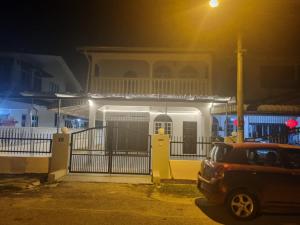 a car parked in front of a house at night at D' Saras Homestay in Sitiawan