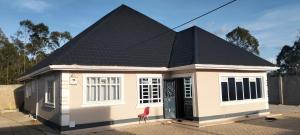 a small house with a red chair in front of it at Sam's comfy homes in Eldoret