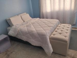a bed and a chair in a bedroom at Sam's comfy homes in Eldoret